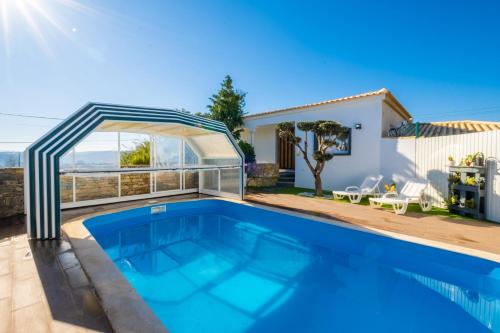 a swimming pool in the backyard of a house at Gaeiras Private Pool in Gaieiras