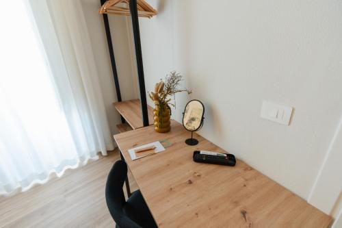 a wooden table with a mirror and a lamp on it at xenia apartments & suite in Siracusa