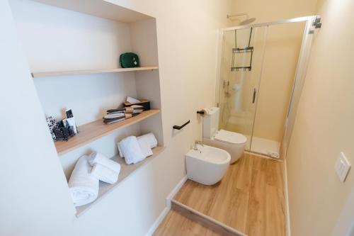 a bathroom with a toilet and a shower at xenia apartments & suite in Siracusa