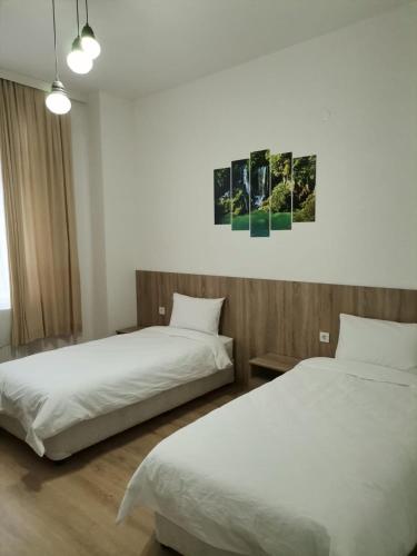 two beds sitting next to each other in a room at Hotel Tatul in Momchilgrad