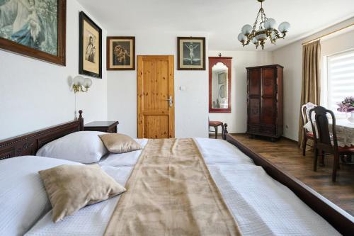 a bedroom with a large bed and a table at Apartamenty Pod Kalwarią Góra Św Anny in Góra Świętej Anny