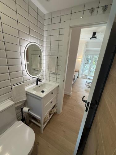 a bathroom with a sink and a toilet and a mirror at La Sorpresa in Huétor Vega