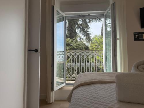 a bedroom with a bed and an open door to a balcony at La Sorpresa in Huétor Vega