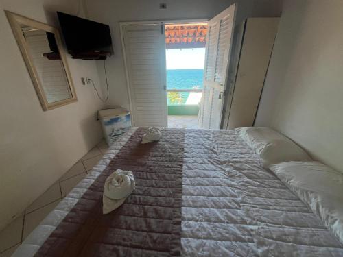 Ein Bett oder Betten in einem Zimmer der Unterkunft Pousada Farol do Morro