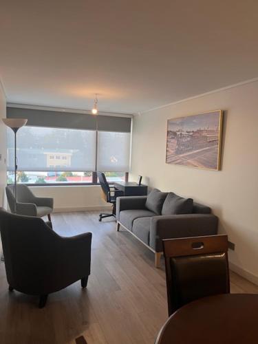 a living room with two couches and a couch at Alto Llaima Suites in Temuco