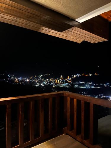 a view of a city at night from a balcony at Kakhri Resort in Mestia