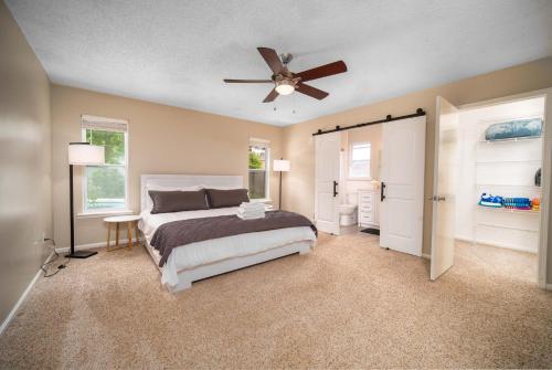a bedroom with a bed and a ceiling fan at Private Heated Pool Arcade Games Sleeps 10 Jacksonville Home in Jacksonville