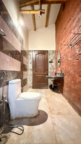 a bathroom with a bath tub and a sink at Kashid Boutique Resort in Sarne