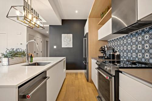 a kitchen with a sink and a counter top at Tremblant Prestige - Verbier 7-204 in Mont-Tremblant
