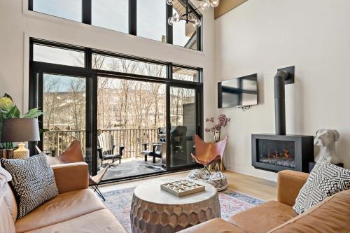 a living room with a couch and a fireplace at Tremblant Prestige - Verbier 7-204 in Mont-Tremblant