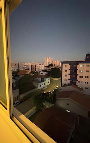 a view of a city from a window at Ap Central - Vista deslumbrante in Ponta Grossa