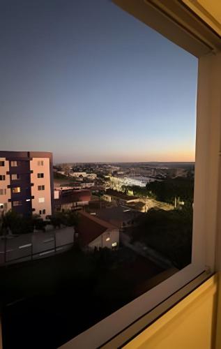 a view of a city from a window at Ap Central - Vista deslumbrante in Ponta Grossa
