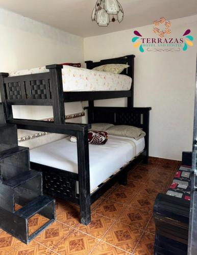 a bedroom with two bunk beds in a room at Terrazas Hotel and Hostel in Taxco de Alarcón