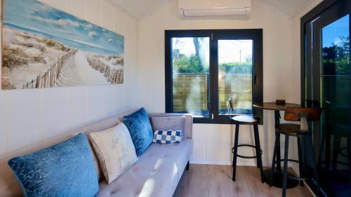a living room with a couch and a window at The Gatwick Cabin With Airport Parking Available in Horley
