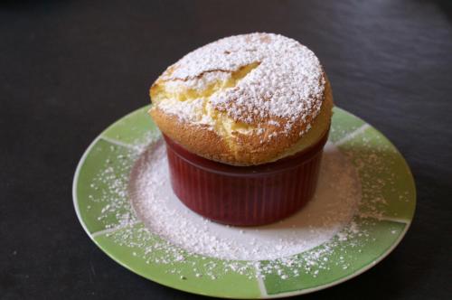 a cupcake on a plate with powdered sugar on it at B&B Vassy Etaule in Avallon