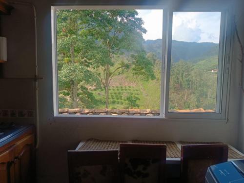 a window in a room with a table and chairs at Habitacion Privada en Jardin cerca al parque in Jardin