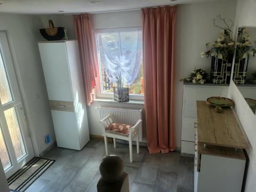 a room with a window and a table and a chair at Sirisferienhaus in Kurort Steinbach-Hallenberg