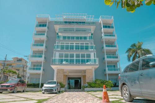 a building with cars parked in front of it at Vista Marina Residence in Boca Chica