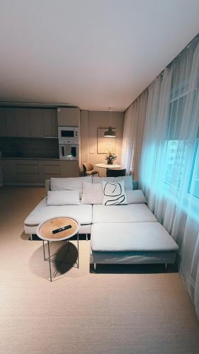 a room with four beds and a table at Amber Shore Apartment in Liepāja