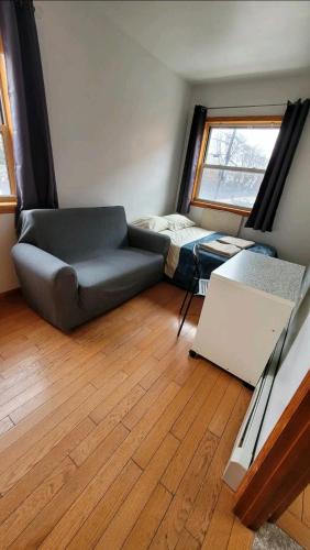 a living room with a couch and a bed at Nice rooms Woodside in Queens