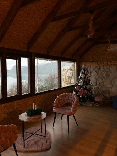 a living room with a christmas tree and a chair at Lake house Zoya in Nikšić