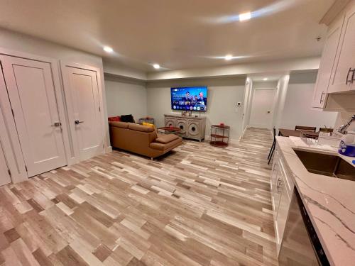 a living room with a couch and a flat screen tv at The Trendy Suite - Upgraded 2BR with Luxe Amenities in Paterson