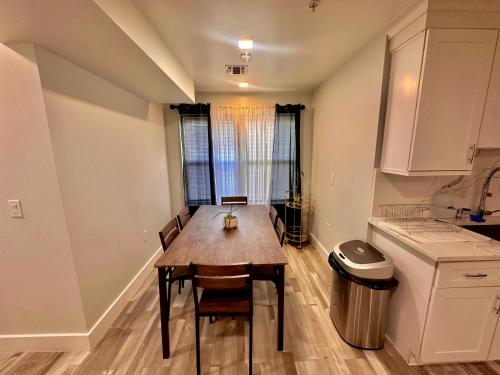 a kitchen with a wooden table and a window at The Trendy Suite - Upgraded 2BR with Luxe Amenities in Paterson