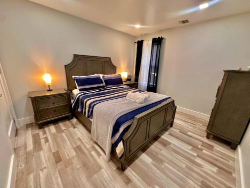 a bedroom with a large bed and two night stands at The Trendy Suite - Upgraded 2BR with Luxe Amenities in Paterson