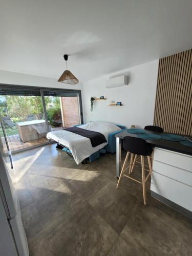 une chambre avec un lit, un bureau et une table dans l'établissement Studio Port de Porto-Vecchio, à Porto-Vecchio