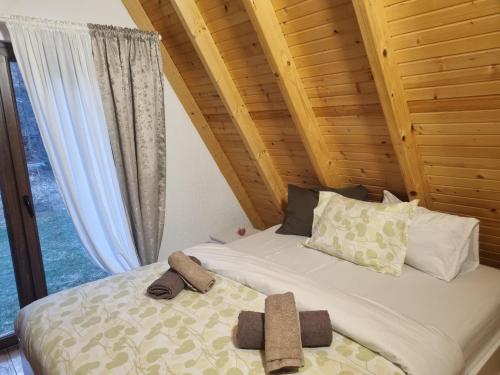 a bedroom with a bed with two towels on it at Sara in Malo Polje