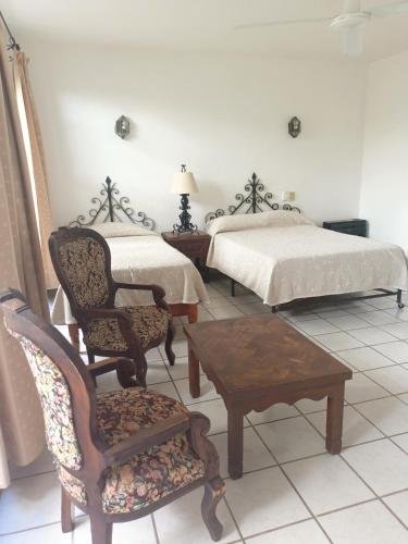 Postel nebo postele na pokoji v ubytování Hotel Quinta Loreto