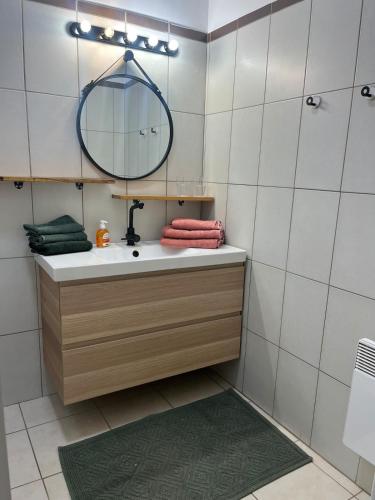 une salle de bain avec un lavabo et un miroir dans l'établissement Appartement T3 centre ville Propriano, à Propriano