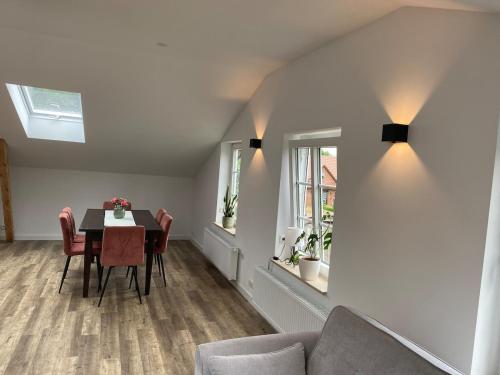 a dining room with a table and a couch at Ferienwohnung Alte Post Redefin für bis zu 6 Personen in Redefin