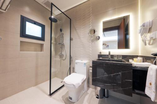 a bathroom with a shower and a toilet and a sink at فندق واحة روز in Jeddah