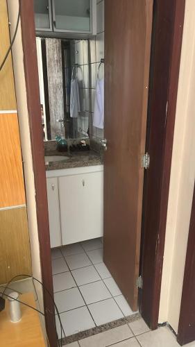 a bathroom with a sink and a mirror at Apto Praia do Meio in São José de Ribamar