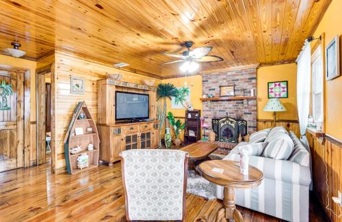 a living room with a couch and a tv at Deck and Hot Tub Lakeside Retreat in Inverness! in Inverness