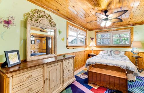 a bedroom with a bed and a mirror at Deck and Hot Tub Lakeside Retreat in Inverness! in Inverness