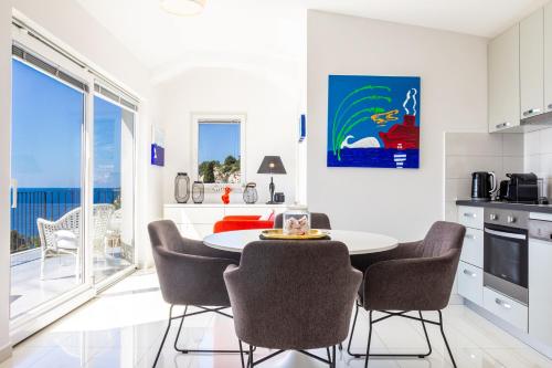 a kitchen with a table and chairs in a room at Blue Bay Residence in Hvar