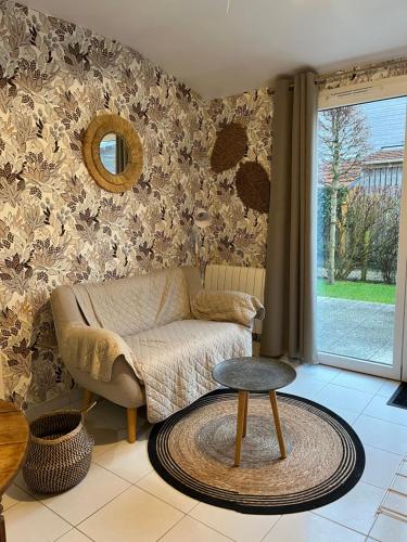 a living room with a couch and a table at Le lodge in Le Crotoy