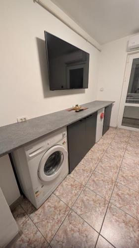 a room with a washing machine and a tv on a counter at ALBA IULIA Cetatea Alba Carolina in Alba Iulia