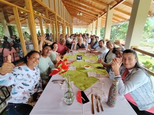 a group of people sitting at a long table at Eco Arazzá in Mera