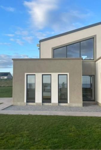 a rendering of a modern house with large windows at Ardmore's Modern Beach House in Ardmore