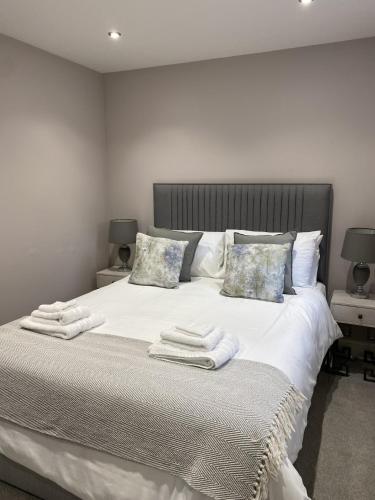 a bedroom with a bed with towels on it at The Gardens Room in Upton