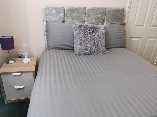 a bedroom with a bed with a headboard and a desk at The Park Lane Retreat - Contractors welcome in Middlesbrough