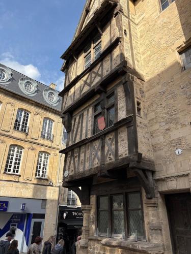 a building with people standing in front of it at Le Nid dHistoire avec vue sur la cathédrale in Bayeux