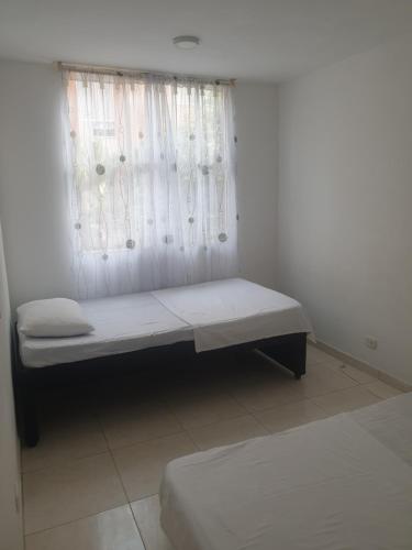 En eller flere senge i et værelse på Apartamento Vacacional