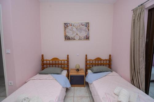 two beds sitting next to each other in a room at Maisonette in Strefi, Ancient Olympia in Stréfion