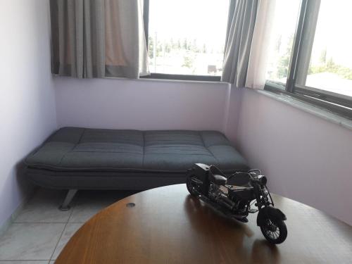 a motorcycle on a table in a room with a couch at Maisonette in Strefi, Ancient Olympia in Stréfion