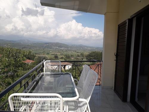 a balcony with a table and chairs and a view at Maisonette in Strefi, Ancient Olympia in Stréfion