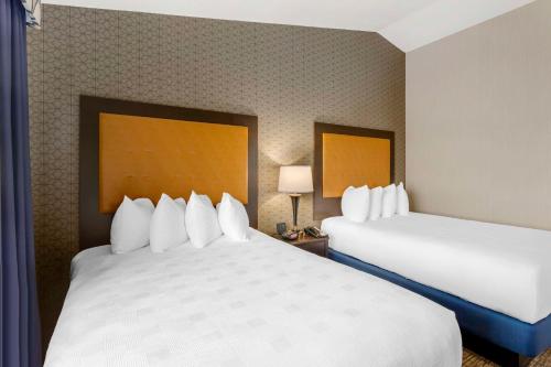 a hotel room with two beds with white pillows at Best Western Plus Grant Creek Inn in Missoula